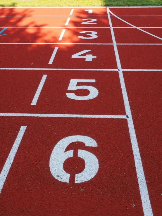 a red running track with numbers painted on it, a photo, pixabay, on a landing pad, eight eight eight, summer sunlight, high res