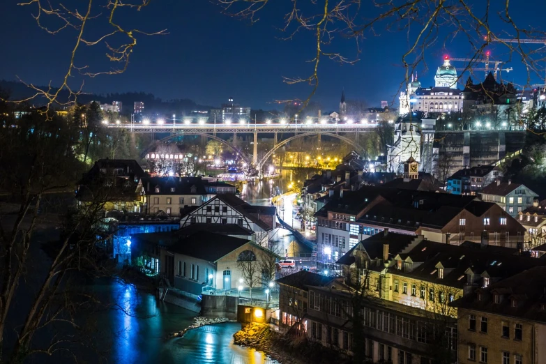 a view of a city at night from the top of a hill, a picture, by Karl Stauffer-Bern, shutterstock, all buildings on bridge, img_975.raw, fully functional, tourist photo