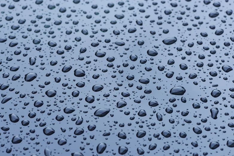 a close up of water droplets on a blue surface, by Jan Rustem, shutterstock, minimalism, grey skies rain, seamless micro detail, transparent black windshield, vertical wallpaper