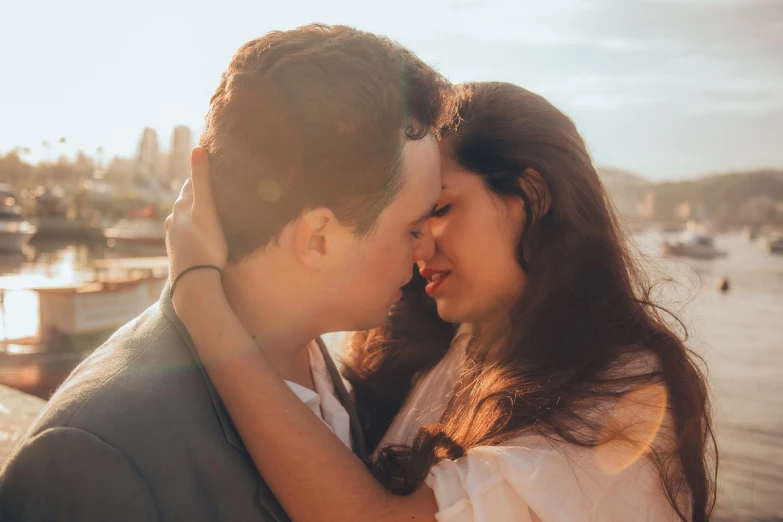 a man and a woman standing next to each other, by Juan O'Gorman, pexels, romanticism, lovely kiss, golden hour closeup photo, san francisco, soft portrait shot 8 k