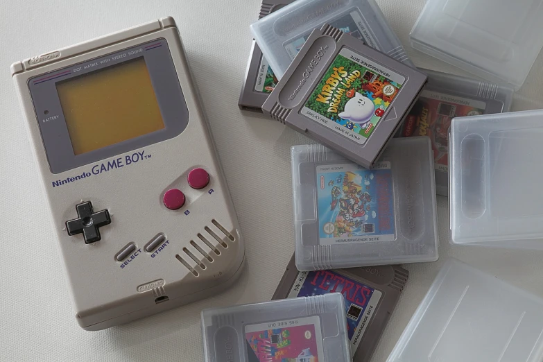 a nintendo game boy sitting on top of a table, a photo, flickr, many screens, game case, close up photograph, blog-photo
