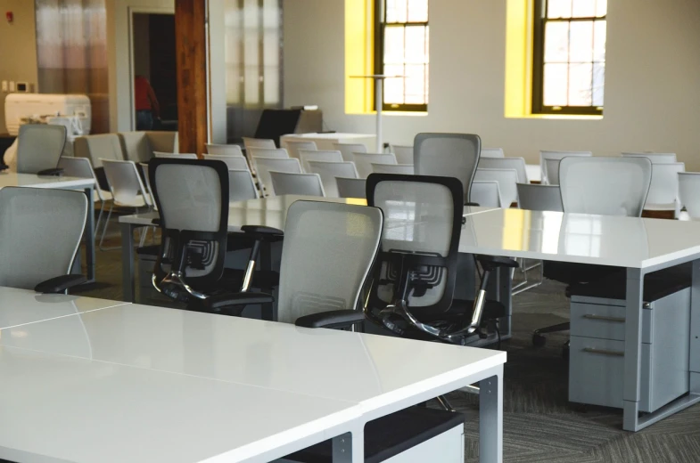 a room filled with lots of white desks and chairs, by John Murdoch, pexels, professional comercial vibe, lacquered, boston, open