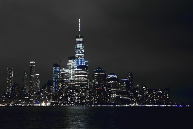 a black and white photo of a city at night, by Joseph Pisani, beautiful blue lights, color corrected, 9 / 1 1, viewed from the harbor