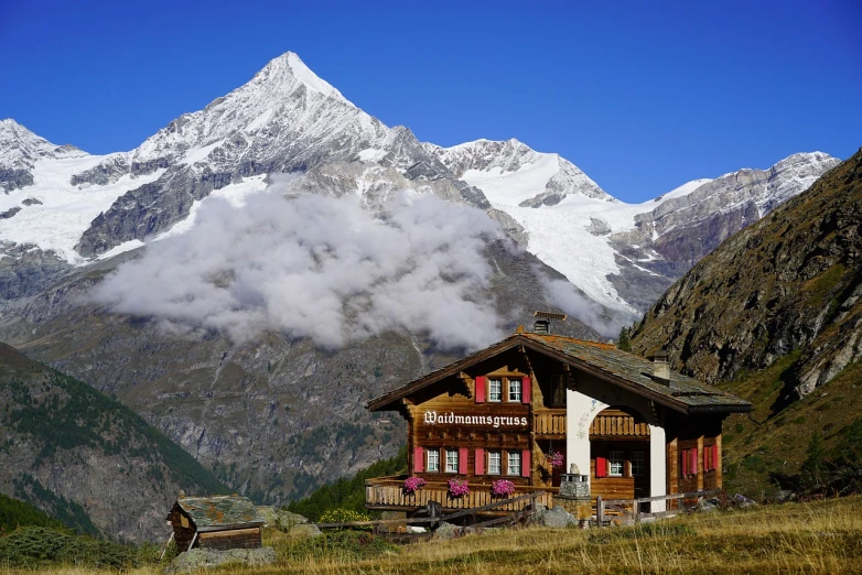 a house on a hill with mountains in the background, a photo, by Werner Andermatt, cafe in the clouds, tourist photo, very very well detailed image, mountaineous background