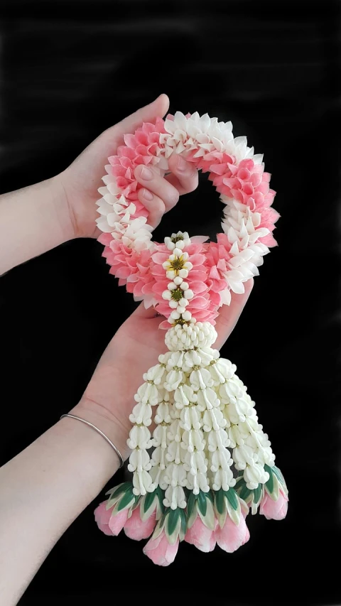 a close up of a person holding flowers in their hands, inspired by Nagasawa Rosetsu, flickr, sōsaku hanga, shell collar!!l, made of candy, thailand art, viral image