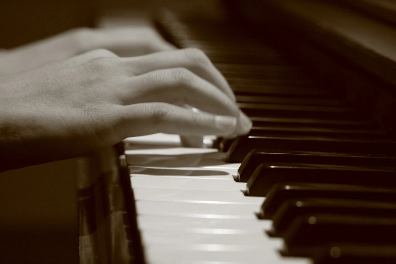 a close up of a person playing a piano, a picture, by Eugeniusz Zak, sepia tone, student, long fingers, benjamin vnuk