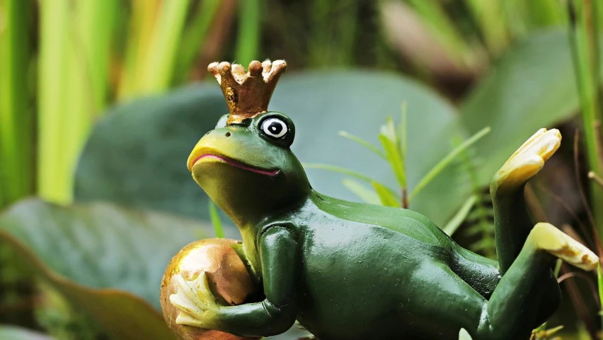 a statue of a frog with a crown on its head, a picture, trending on pixabay, 👰 🏇 ❌ 🍃, pvc figurine, olive, photograph credit: ap