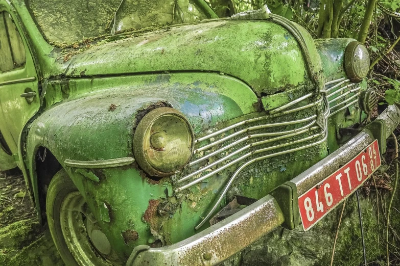 an old green car is parked in the woods, by Raymond Normand, pixabay contest winner, photorealism, hdr detail, photorealism. trending on flickr, weathered face, hyperdetail