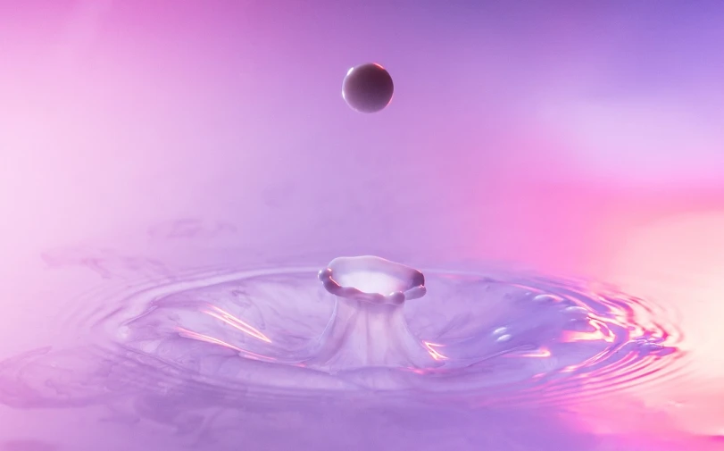 a drop of water falling into a pool of water, a 3D render, unsplash, conceptual art, purple and pink, dmt imagery. octane render, focus stacking, cervix awakening