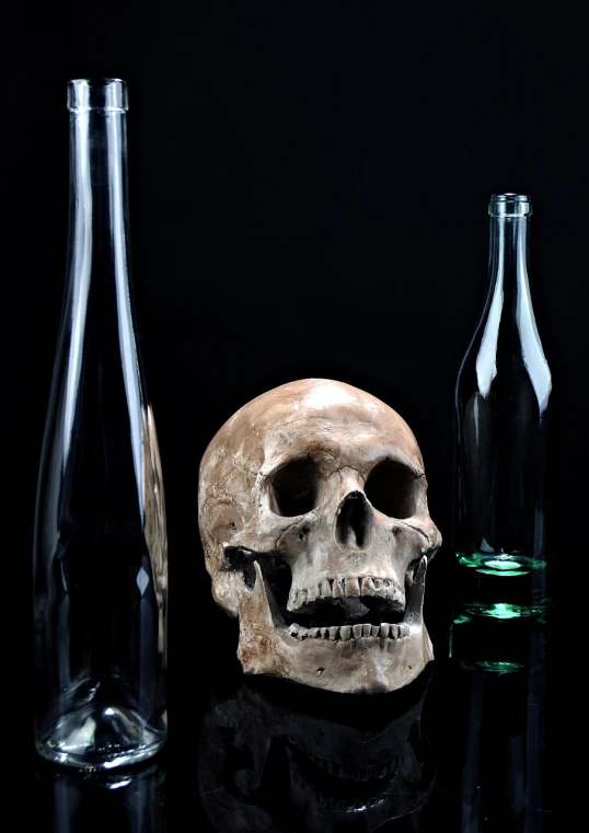 a skull sitting on top of a table next to bottles, a still life, pixabay, close - up studio photo, glass skin, hamlet, on a flat color black background