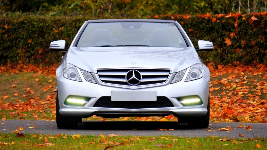 a silver car is parked on the side of the road, by Julian Allen, trending on pixabay, mercedez benz, convertable, frontlight, 😃😀😄☺🙃😉😗