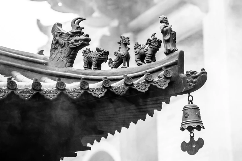 a bell hanging from the side of a building, a black and white photo, by Li Mei-shu, pexels, cloisonnism, an altar of a temple, detailed clay model, flying mythical beasts, 24mm tilt-shift