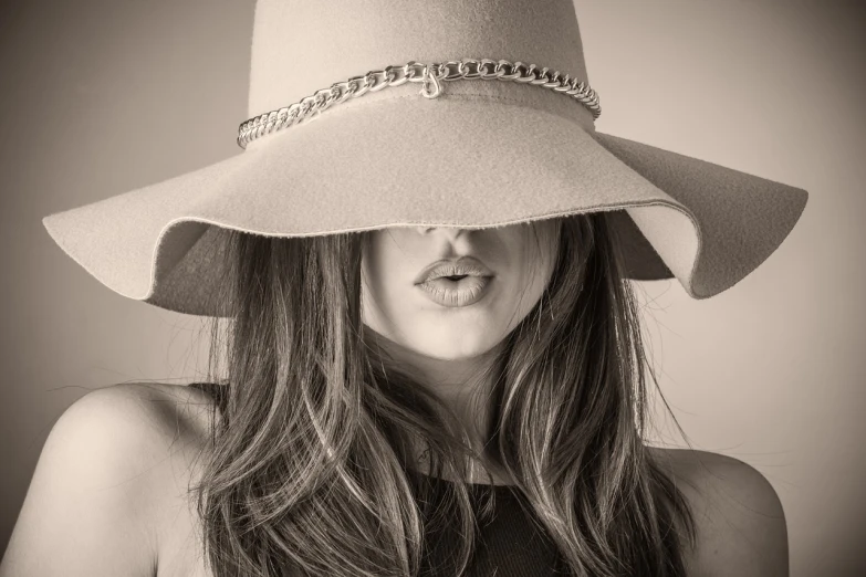 a black and white photo of a woman wearing a hat, inspired by Dora Maar, pixabay contest winner, sepia toned, licking out, jill stingray, young southern woman