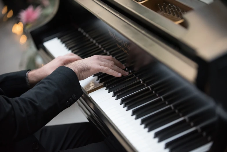 a close up of a person playing a piano, michael pangrazio, gentleman, high res, high details photo