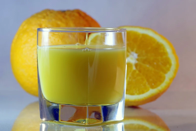 a glass of orange juice next to an orange, a picture, by Jan Rustem, octane renderer”, closeup photo, full of greenish liquid, recipe