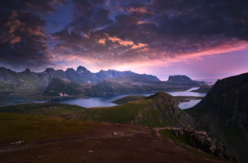 a large body of water sitting on top of a lush green hillside, a matte painting, by Sebastian Spreng, pexels contest winner, romanticism, mountains and colorful sunset!!, norway mountains, devils horns, vertical wallpaper