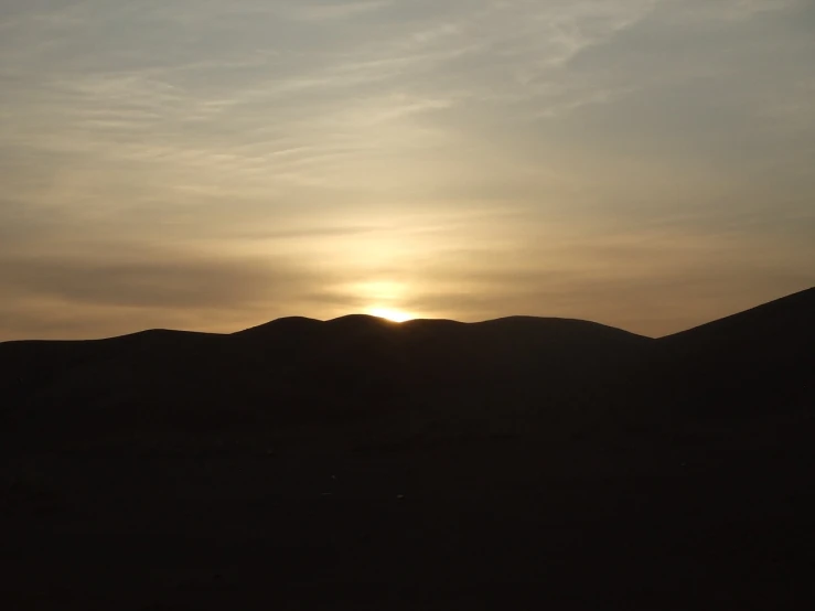 a person flying a kite at sunset in the desert, inspired by Georg Friedrich Schmidt, flickr, hurufiyya, marrakech, viewed from very far away, two suns, rolling hills