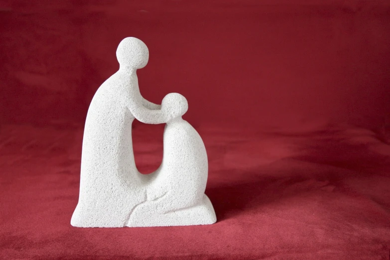 a figurine of a man holding a child, flickr, figuration libre, on a red background, finely textured, prayer, faceless people