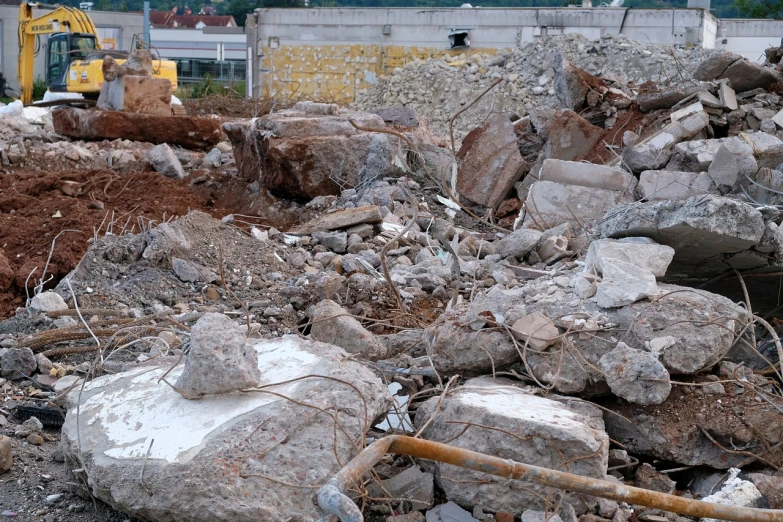 a pile of rocks sitting on top of a pile of dirt, a picture, destroyed modern buildings, materials white stone, 2 0 1 0 photo