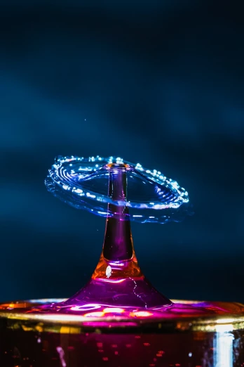 a water drop with a ring of light coming out of it, art photography, glass spaceship, twisted energy flow, colorful coctail, taken with canon 8 0 d