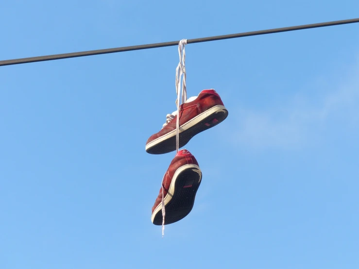 a pair of red shoes hanging from a wire, by Niko Henrichon, hurufiyya, 3 meters, caulfield, unwind!, looping