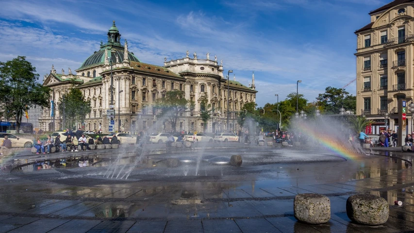 a group of people standing around a water fountain, viennese actionism, epic buildings in the center, sunny morning, october, srgb