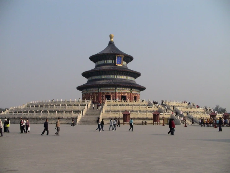 a group of people standing in front of a building, a picture, by Li Di, flickr, cloisonnism, temple of heaven, stepping on towers, a huge, terminal