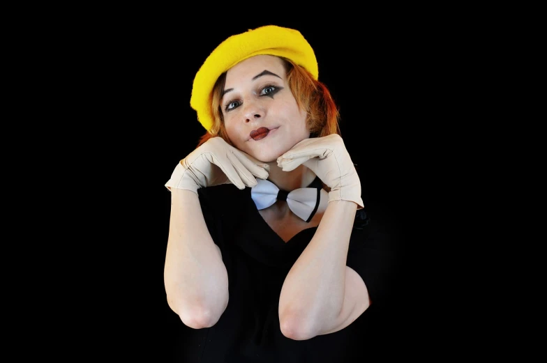 a woman wearing a yellow hat and gloves, a portrait, inspired by Grete Stern, flickr, on black background, mime, childish look, cinematic outfit photo