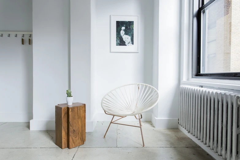 a white chair sitting in a room next to a window, a portrait, inspired by Isamu Noguchi, serial art, wooden side table, professional product photo, rick dai, circular