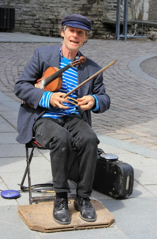 a man sitting on a chair playing a violin, a photo, helsinki, 15081959 21121991 01012000 4k, happy!!!, begging
