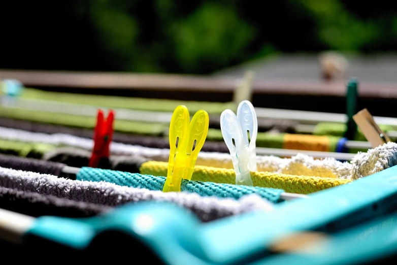 a bunch of clothes hanging on a clothes line, a picture, figuration libre, rabbit ears, macro 8mm photo, with fluo colored details, having fun in the sun