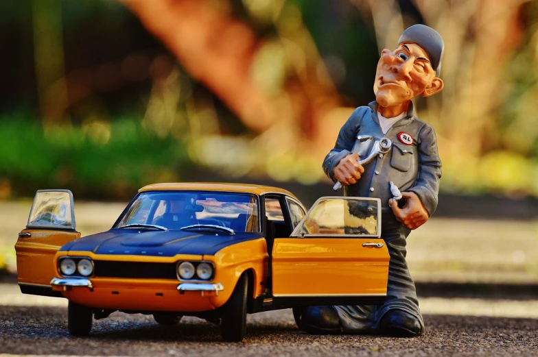 a figurine of a man standing next to a toy car, by Toyen, pexels contest winner, photorealism, old charismatic mechanic, the creature sells a used car, taxi, golden detailing