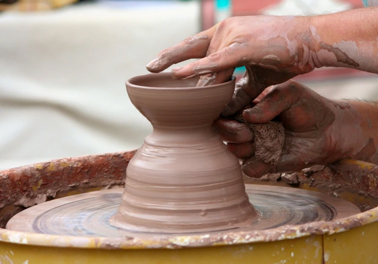 a close up of a person making a pot on a potter's wheel, flickr, process art, stock photo, focus on the object, marketing photo, artistic interpretation