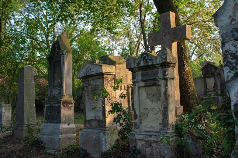 a group of tombstones sitting in the middle of a forest, by Viktor de Jeney, flickr, dappled in evening light, savannah, mausoleum tall ruins, kreuzberg