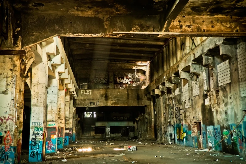 a run down building with graffiti all over it, by William Woodward, flickr, post apocalyptic palace interior, under bridge, tourist photo, stock photo