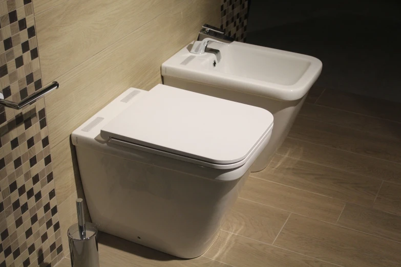 a white toilet sitting next to a sink in a bathroom, by Bernardino Mei, pixabay, art deco, with two front pockets, made of high tech materials, white tile on the floor, news photo