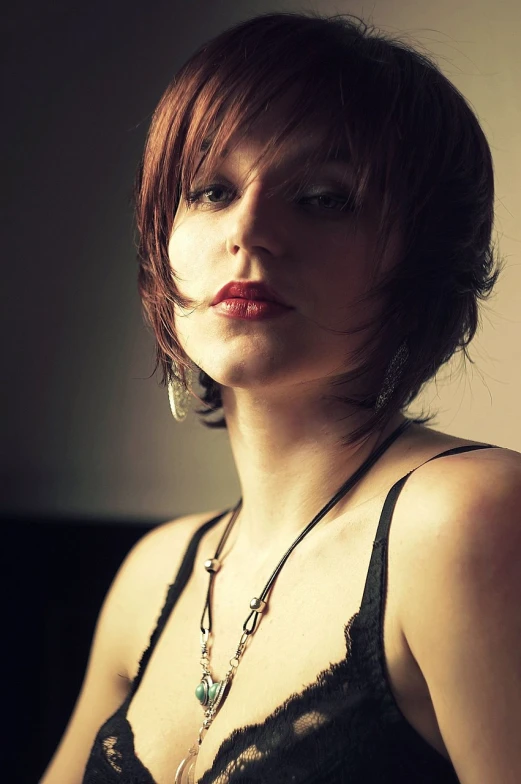 a woman in a bra top posing for a picture, inspired by Elsa Bleda, flickr, copper short hair, denoise deep depth of field, wearing elegant jewellery, shag haircut