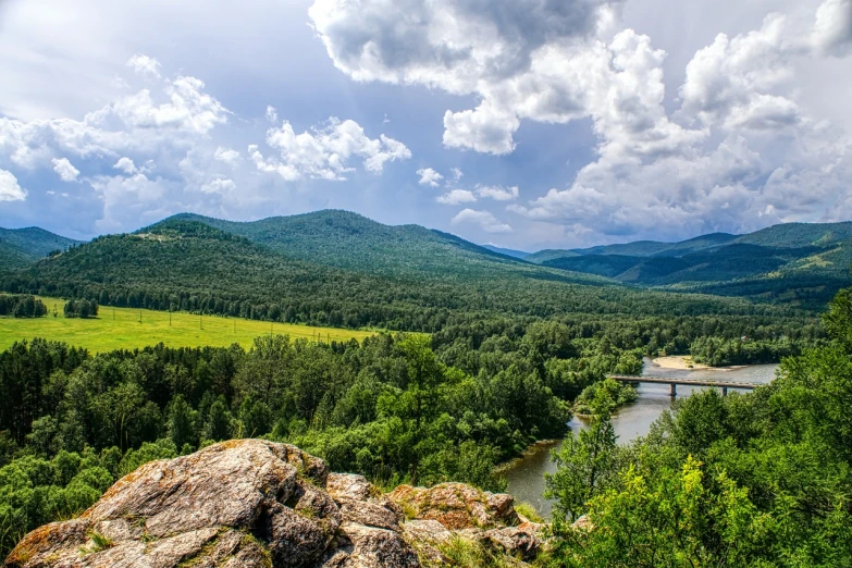 a river running through a lush green valley, a picture, by Svetlin Velinov, shutterstock, romanticism, summer siberian forest taiga, in the distance is a rocky hill, hdr photo, view from the top