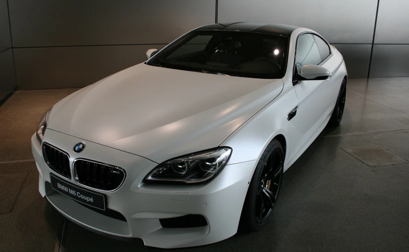 a white bmw car parked in a garage, flickr, white gold black, semi-transparent, f12, the console is tall and imposing