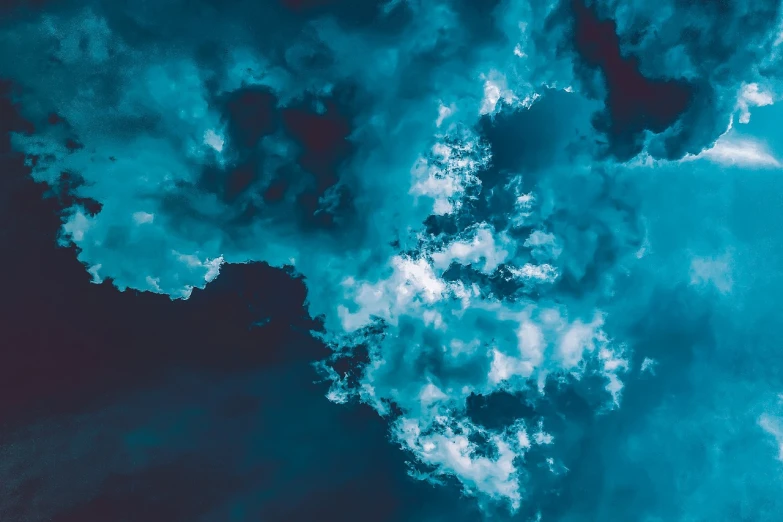 a plane flying through a cloudy blue sky, inspired by Elsa Bleda, romanticism, dark gorgeous clouds, blue and cyan colors, whorl. clouds, looking up