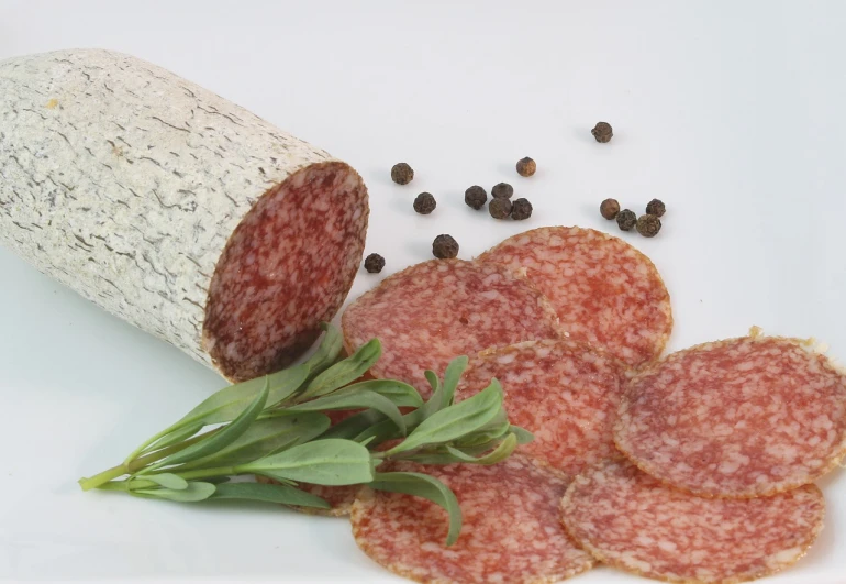 a white plate topped with slices of salami, by Dietmar Damerau, white with black spots, with vegetation, catalog photo, -h 1024