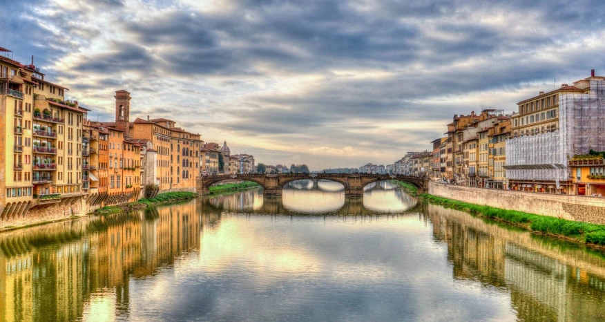 a river running through a city next to tall buildings, a picture, by Bernardino Mei, pexels contest winner, renaissance, florence, serene overcast atmosphere, old bridge, wikimedia