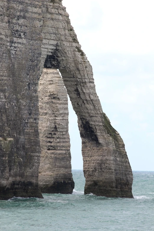 a couple of large rocks sticking out of the water, romanticism, huge support buttresses, northern france, hanging veins, portal 3