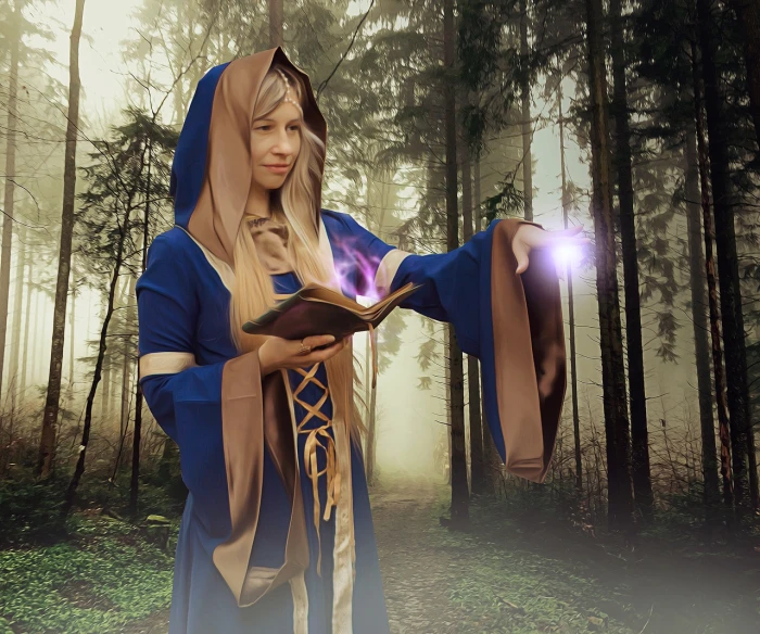 a woman in a blue dress holding a book in a forest, a photo, inspired by Charmion von Wiegand, shutterstock, fantasy art, wearing star filled mage robes, karthus from league of legends, realistic cosplay, wearing brown robes