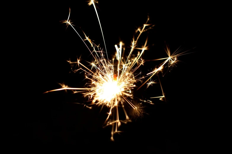 a close up of a sparkler in the dark, light and space, istockphoto, sparkles and glitter, high res photo, ecstatic