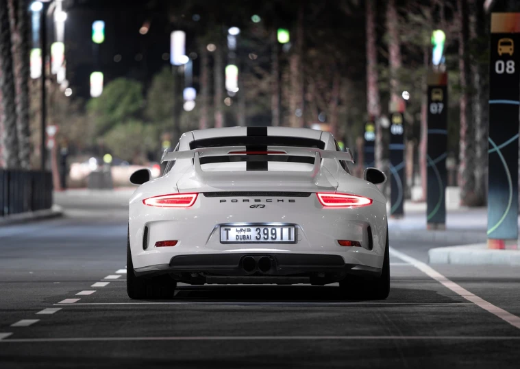 a white car driving down a street at night, a picture, tumblr, porsche rsr, back lit, white and grey, amazing wallpaper