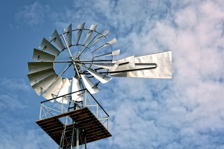 a close up of a windmill on a cloudy day, a portrait, kinetic art, silver, watertank, wikimedia commons, outdoor photo