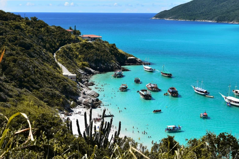 a group of boats floating on top of a body of water, a photo, by Felipe Seade, shutterstock, turquoise water, brazil, sparkling cove, usa-sep 20