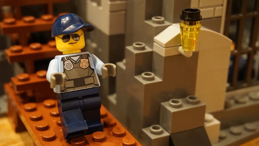 a lego man standing on top of a table, a picture, flickr, post apocalyptic police station, cinematic blue and gold, in an underground laboratory, closeup - view