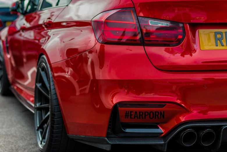a red car parked on the side of the road, inspired by Hans Erni, unsplash, purism, acronym, bmw, skin detail, fart
